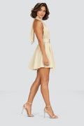 Elodie Halter Mini Dress in Beige – studio side view